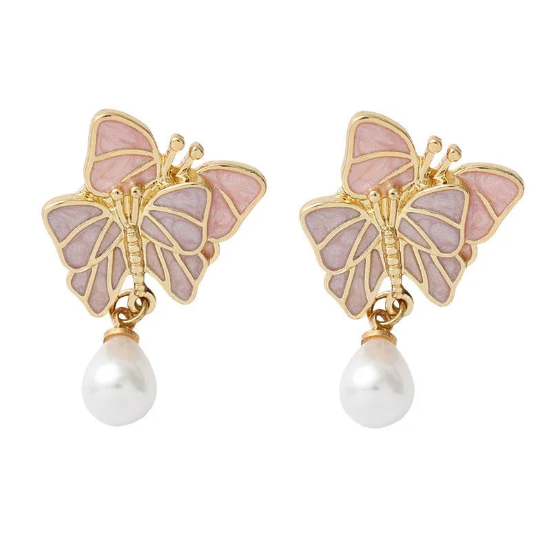 Vintage enamel butterfly brooch with pearl accents on alloy base