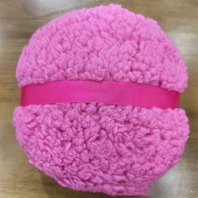 Oversized rectangular plush powder puff in pink on a white background.