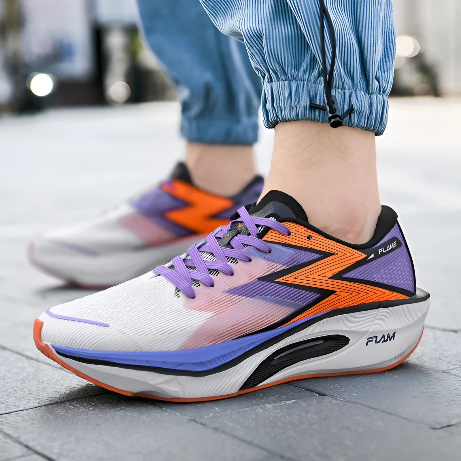 Low-top running shoes with carbon plate in orange, white, pink, sand, and purple colour options on a white background.
