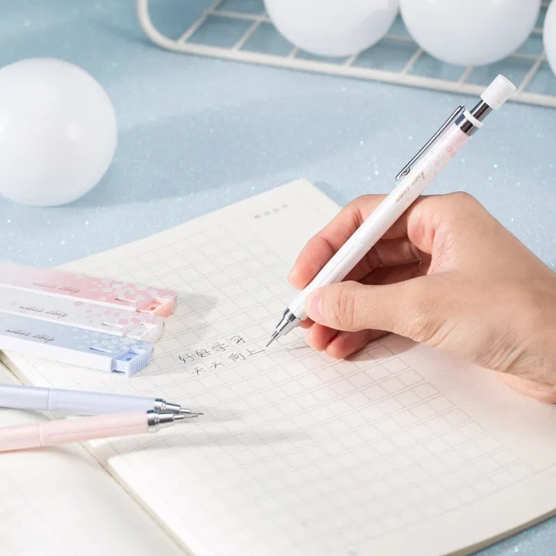 Three 0.5mm Sakura cartoon automatic pencils with HB refill boxes
