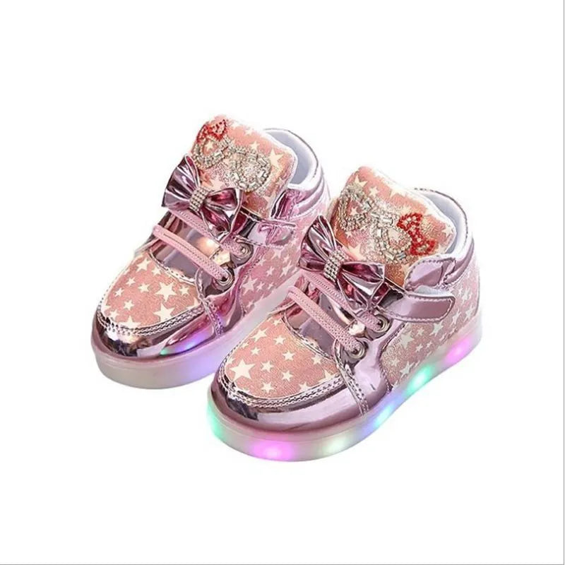 Golden children's LED sneakers with a light-up magic button on the heel