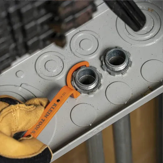 Three colour-coded wrenches in orange, grey and black showing crescent, magnetic and catheter locking designs