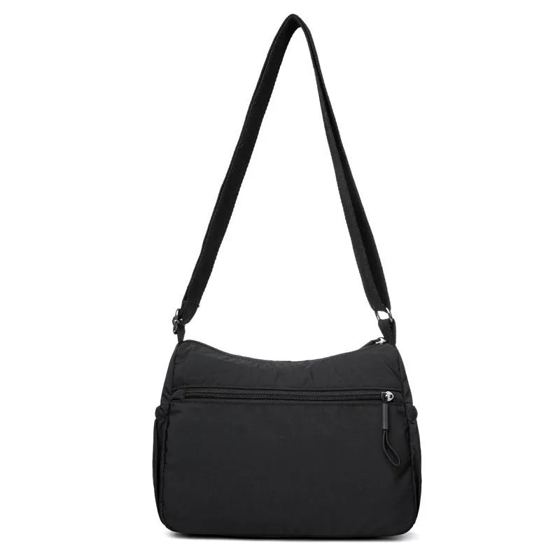 Water-repellent nylon crossbody cloth bag in black, grey or red with internal zipper compartments