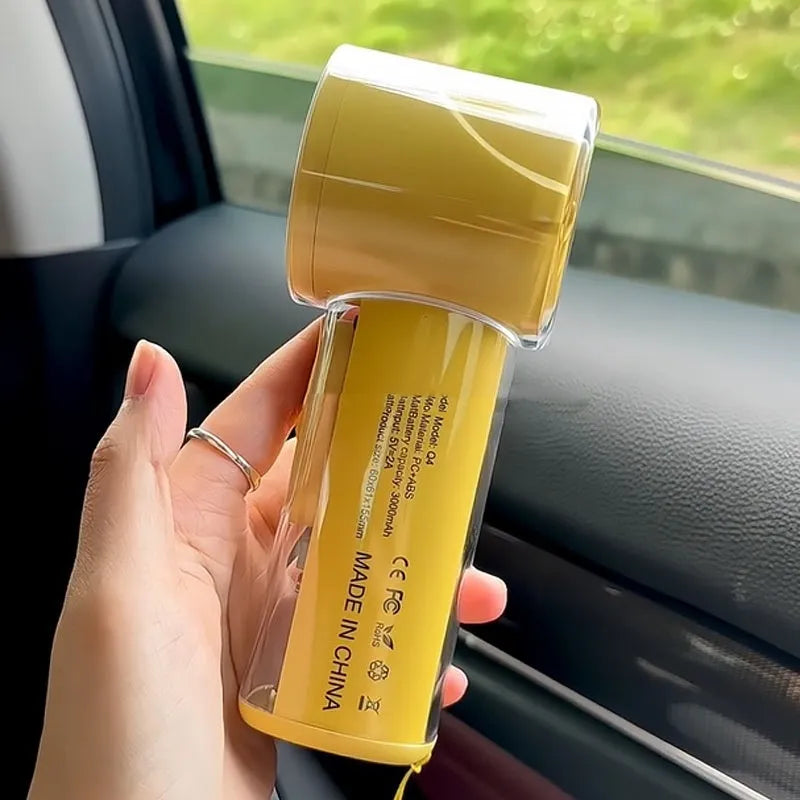 Small yellow handheld portable fan with refrigeration ice compress function showing compact design