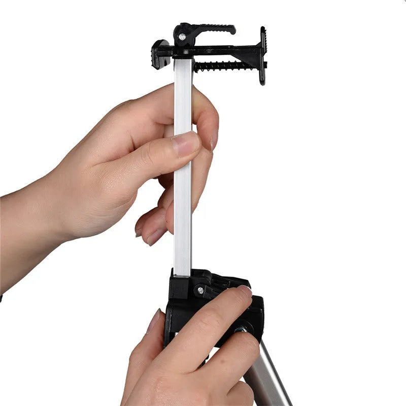 Silver aluminium alloy adjustable easel with metal tray in collapsed position on a tabletop