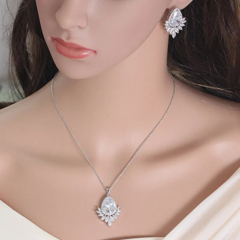 AAA formal jewellery set with chain link necklace, earrings, and pendant featuring cubic zirconia stones in blue, red, or white.