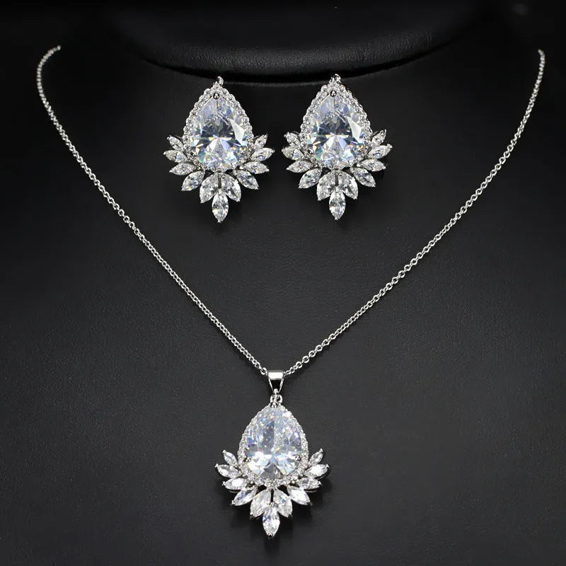 AAA formal jewellery set with chain link necklace, earrings, and pendant featuring cubic zirconia stones in blue, red, or white.