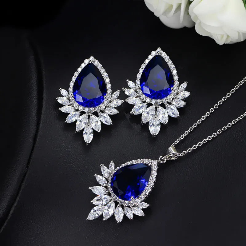 AAA formal jewellery set with chain link necklace, earrings, and pendant featuring cubic zirconia stones in blue, red, or white.