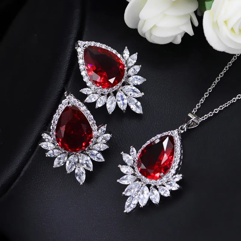 AAA formal jewellery set with chain link necklace, earrings, and pendant featuring cubic zirconia stones in blue, red, or white.
