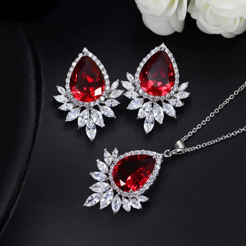 AAA formal jewellery set with chain link necklace, earrings, and pendant featuring cubic zirconia stones in blue, red, or white.