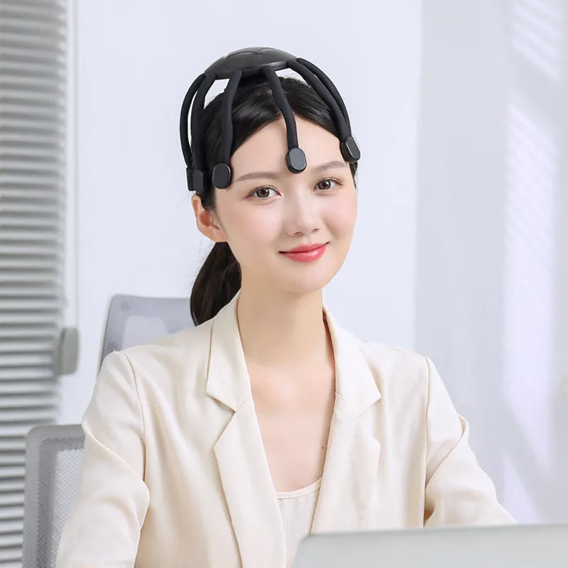Black handheld head massager with multiple vibrating nodes for scalp stimulation