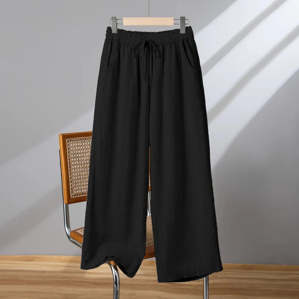 Women's straight-leg casual trousers in apricot colour with an elastic waistband and lace-up drawstring detail.