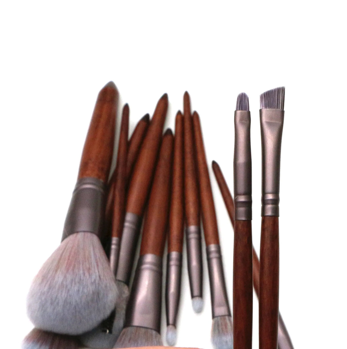 11-piece makeup brush set with synthetic hair heads, matte coffee aluminium ferrules, and natural wood handles