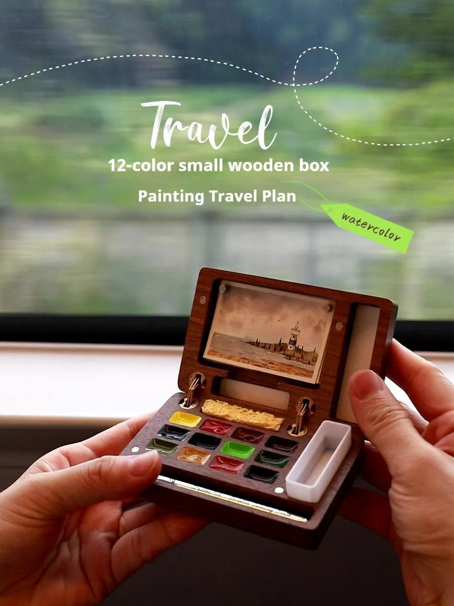 Mini walnut wood watercolour paint box set open showing internal brush and paint compartments.