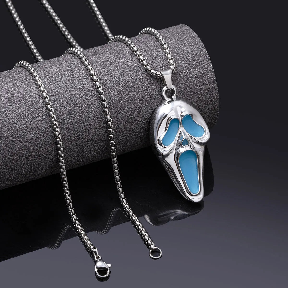 Exaggerated skull luminous mask pendant necklace on square pearl chain, available in luminous blue, luminous green, and hollow out colours
