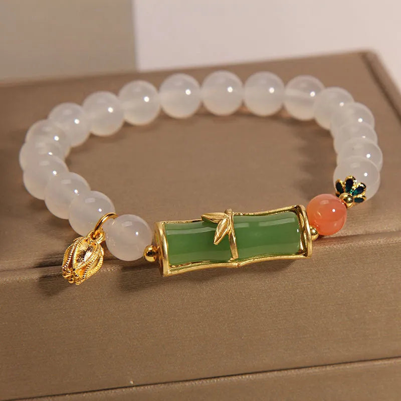 Women's white agate and jade beaded bracelet with bamboo joint connector in retro Chinese style.