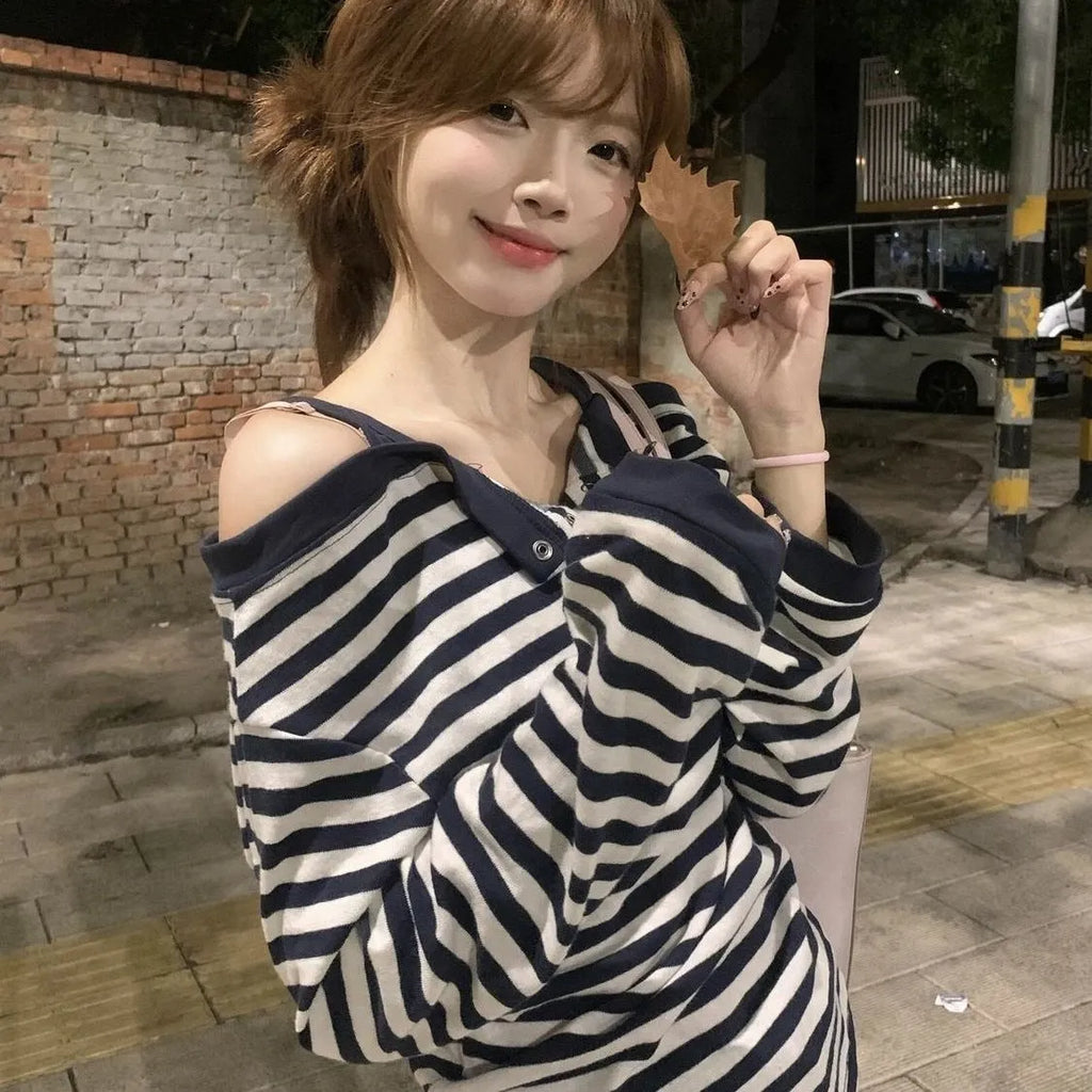 Dark blue women's oversized long sleeve t-shirt with stripes and embroidery detail.