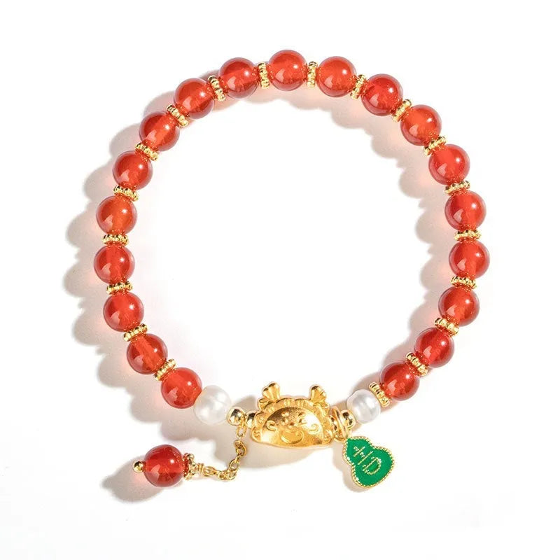 Natural agate bracelet with diamond-shaped beads and a dragon zodiac charm on a wrist.