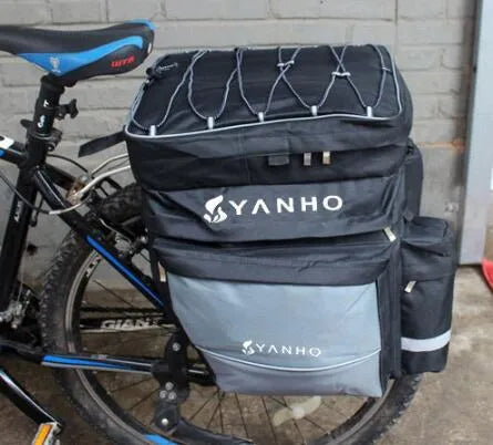 Black mountain bike pannier bag 43L 600D nylon with rain cover and reflective strips attached to bicycle shelf
