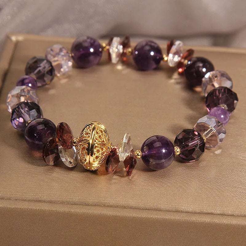 Purple crystal bracelet with pumpkin beads, wind chime motifs, and rhinestone decorations on adjustable band