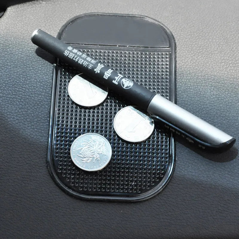 Black silicone spider anti slip mat for car dashboard measuring 13 by 7 centimetres