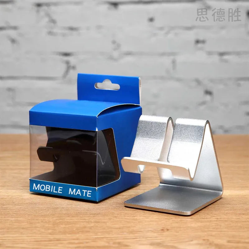 Aluminium alloy foldable tablet stand in gold holding a smartphone on a desk