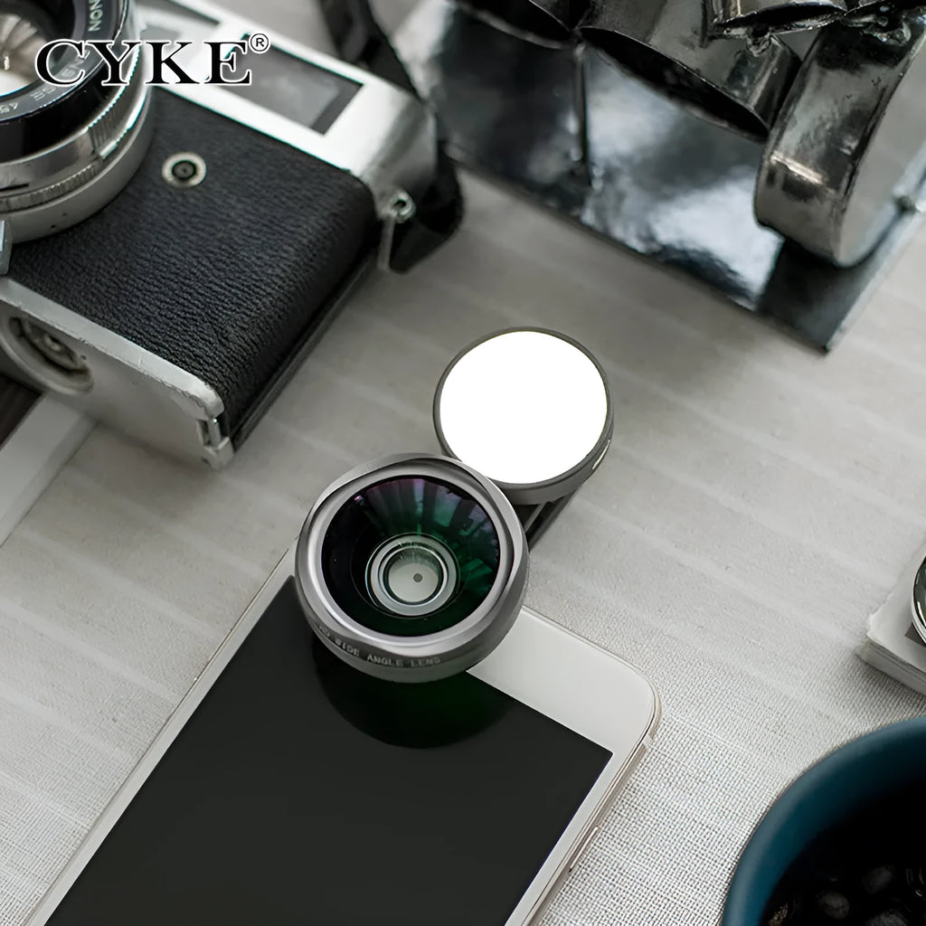 Universal smartphone camera lens attachment kit with wide-angle, macro, and fisheye lenses, LED lights, and a tripod grip.