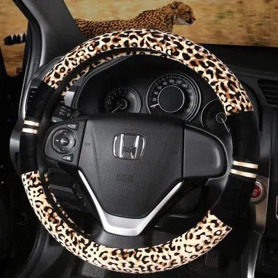 Winter plush car steering wheel cover in beige with leopard grain pattern on a GM steering wheel