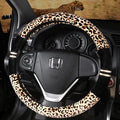 Winter plush car steering wheel cover in beige with leopard grain pattern on a GM steering wheel