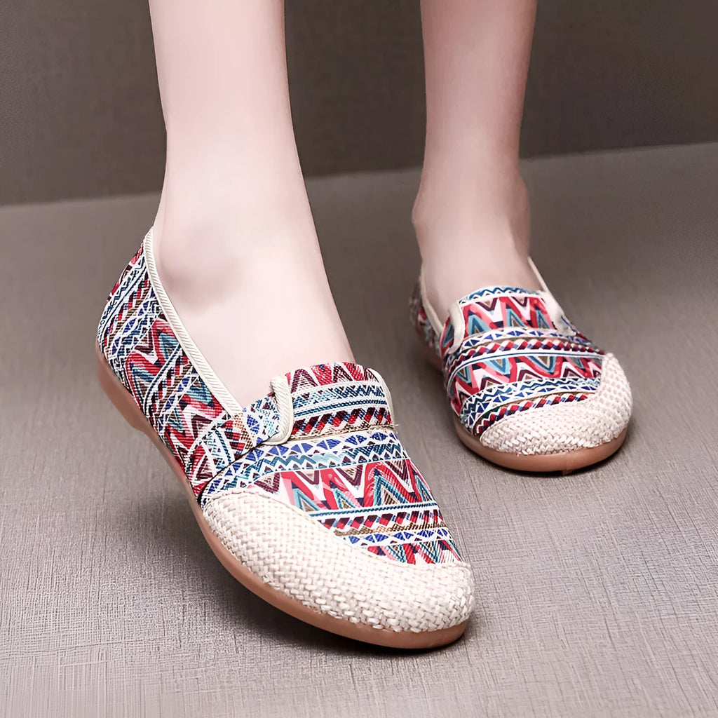 Women's ethnic style flat heel cloth shoes with colour stitching and shallow mouth design.