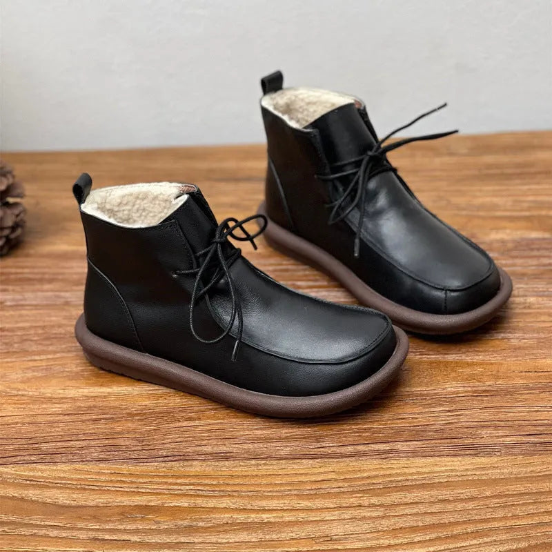 Women's black cowhide ankle boots with flat heel and round toe, showing 9cm sock height