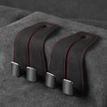 Alloy metal car seat gap storage hook with suede lining in black colour, shown flipped open.