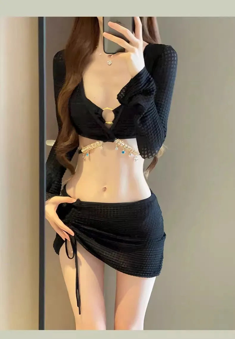 Women's long sleeve bikini swimsuit in black or white colours for swimming activities