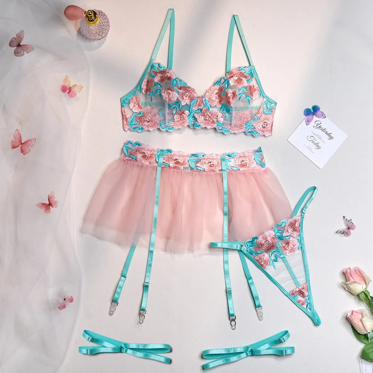 Pink women's mesh pettiskirt and bikini set with embroidery detail.