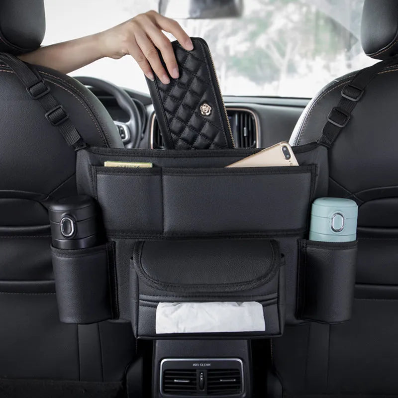 Black leather car seat storage bag with integrated hanging armrest tissue box between vehicle seats