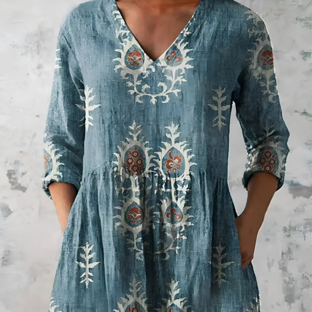 Women's loose-fitting dress with a wave print pattern, wide waist, and three-quarter length sleeves.