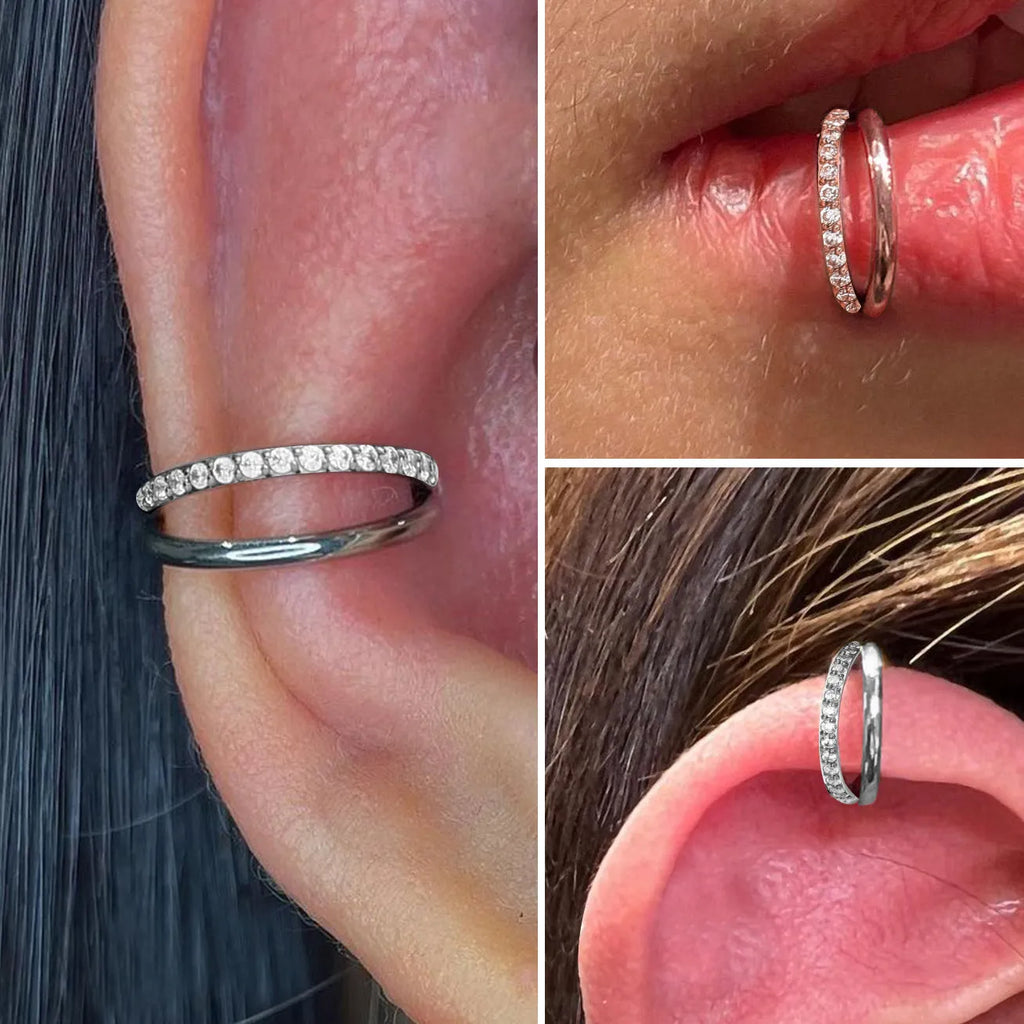 Titanium alloy nose ring body jewellery in silver colour on a plain background.