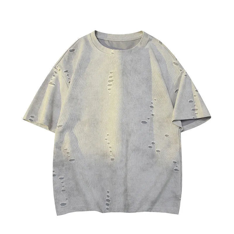 Man wearing a loose fit blue cotton blend T-shirt with ripped detail on the sleeve.