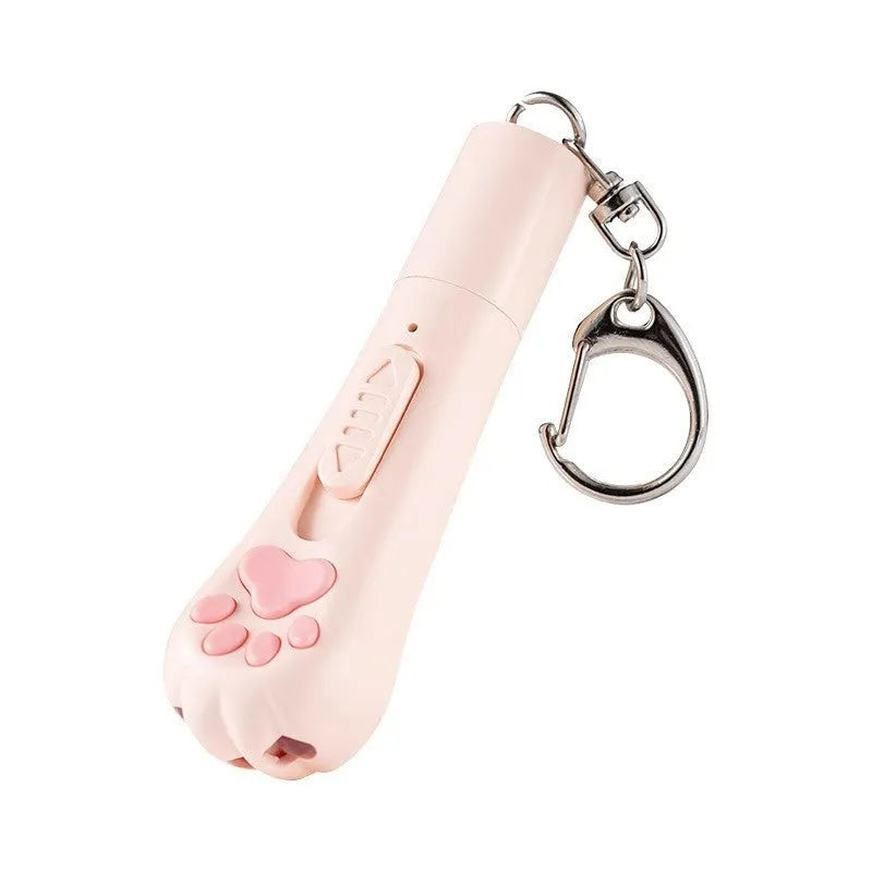 Pink self-playing cat teaser wand toy with USB charging cable on a table.