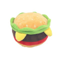 Plush pet toys shaped like a hamburger, french fries, and a milkshake cup on a plain background.