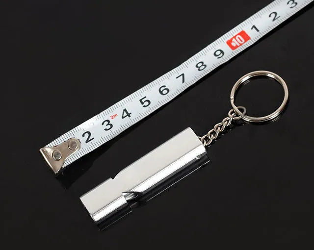 Silver and gold aluminium alloy outdoor survival whistle with double hole design.