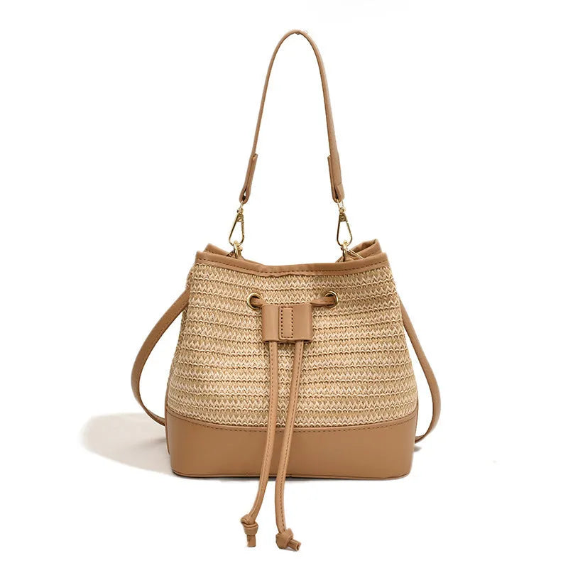 Woven straw women's crossbody bucket bag in horizontal square shape with adjustable shoulder strap