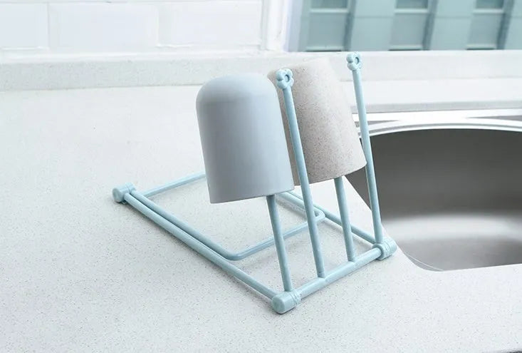Foldable plastic dishcloth shelf in light blue with bottles stored vertically