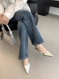 Women's black pointed leather low-heel shoes with thin decorative straps and a rubber sole.