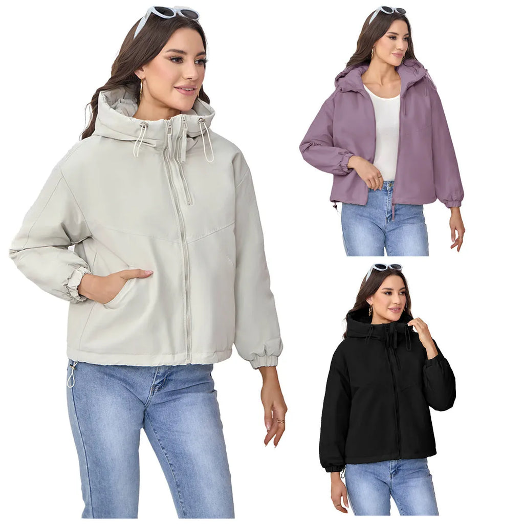 Women's loose-fit hooded shell jacket in grey, black, or purple colours, made from polyester fabric.