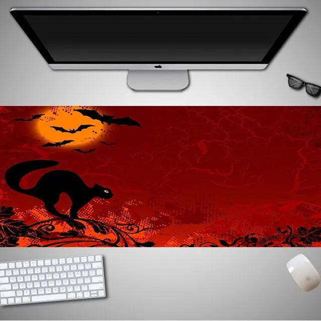 Oversized Halloween pattern rubber cloth mouse pad on a desk with non-slip base.