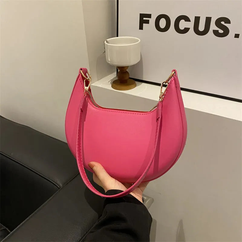 21cm round PU underarm bag with single shoulder strap in seven colour options showing mobile phone pocket