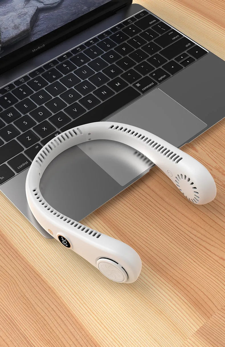 White portable bladeless neck fan hanging around a neck with USB charging cable.