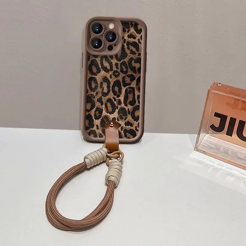 Brown leopard print silicone lanyard phone case for iPhone on a table