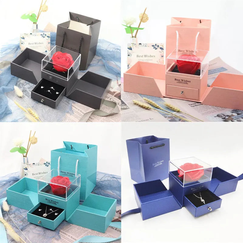 Blue jewellery gift box open with a plastic eternal rose inside, next to a pair of earrings.